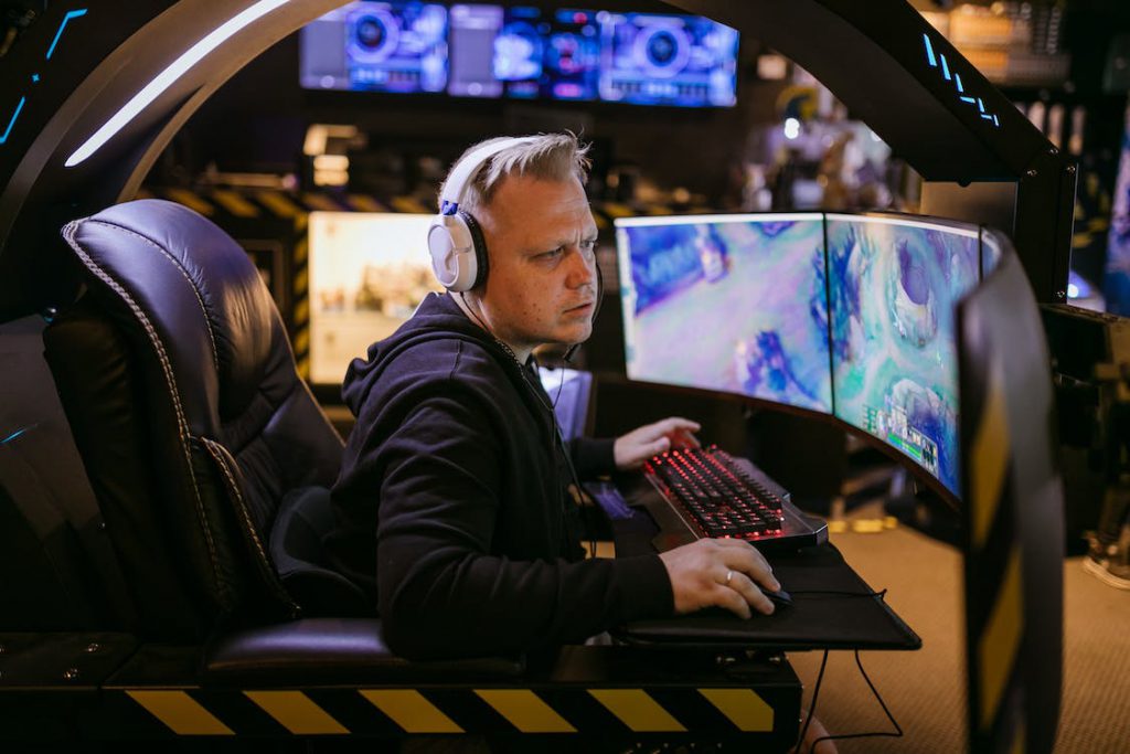 A guy working hard with a multi-monitor display